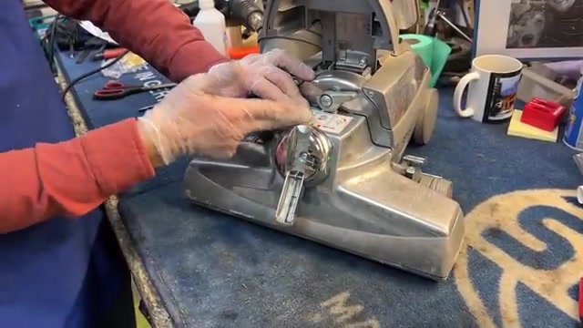Locate the belt lifter (red knob on the side of the vacuum head).