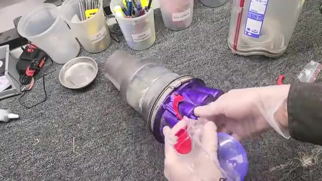 Empty the canister and manually open the bottom lid.