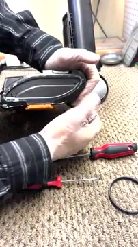 Unclip and remove the front cover plate from the vacuum head.