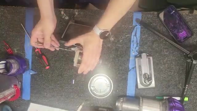 Remove the cyclone assembly by unscrewing 6 screws: 4 on top and 2 in the back.