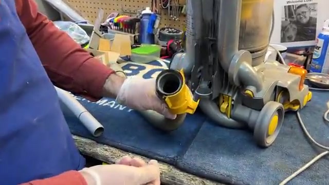 Locate the clip holding the hose to the machine.