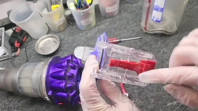 Locate the springy teeth on both sides of the trigger mechanism.