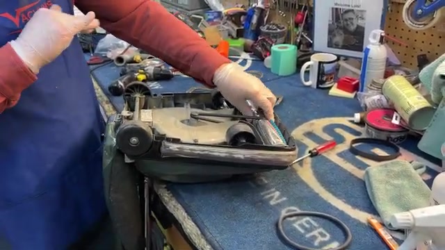 Roll the brush roller backward by hand several times to ensure the belt seats properly.