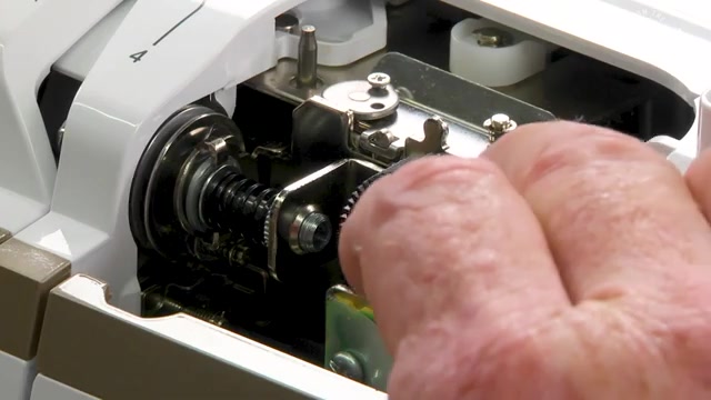 Rotate the tension mechanism counterclockwise to lift and open the tension discs.
