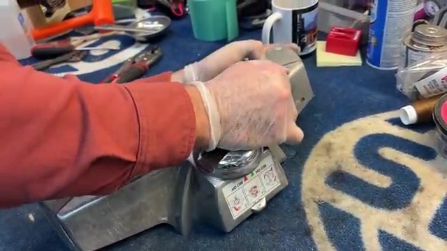 Place the new belt around the center of the brush roller.