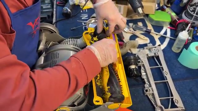 Insert the brush roller while holding the belt up.