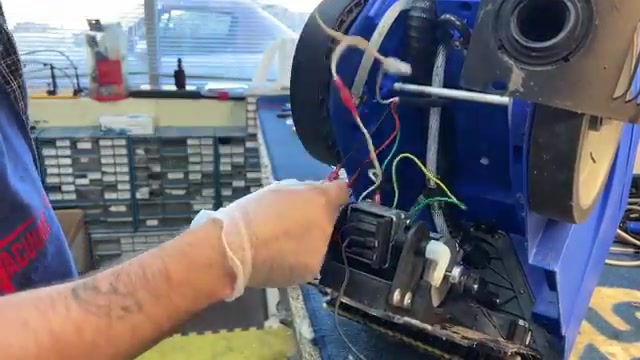 Cut the zip tie holding the electrical wire bundle.