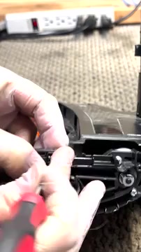 If the brush housing release mechanism fell out, pull back its spring slightly.