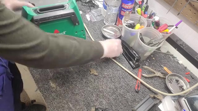 Replace the four plastic screws to secure the hose assembly.