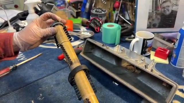 With the vacuum unplugged, turn it over to access the brush roller.